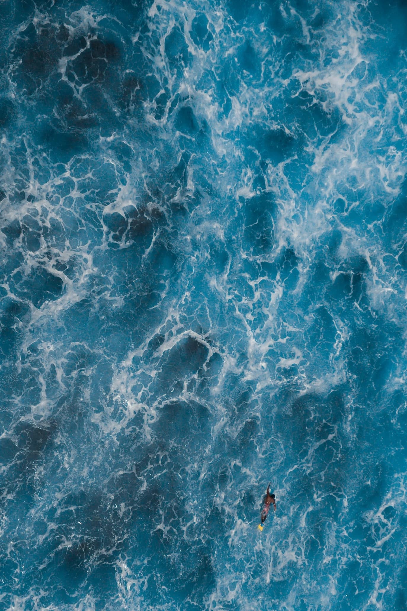 Aerial view of textured deep blue ocean water.