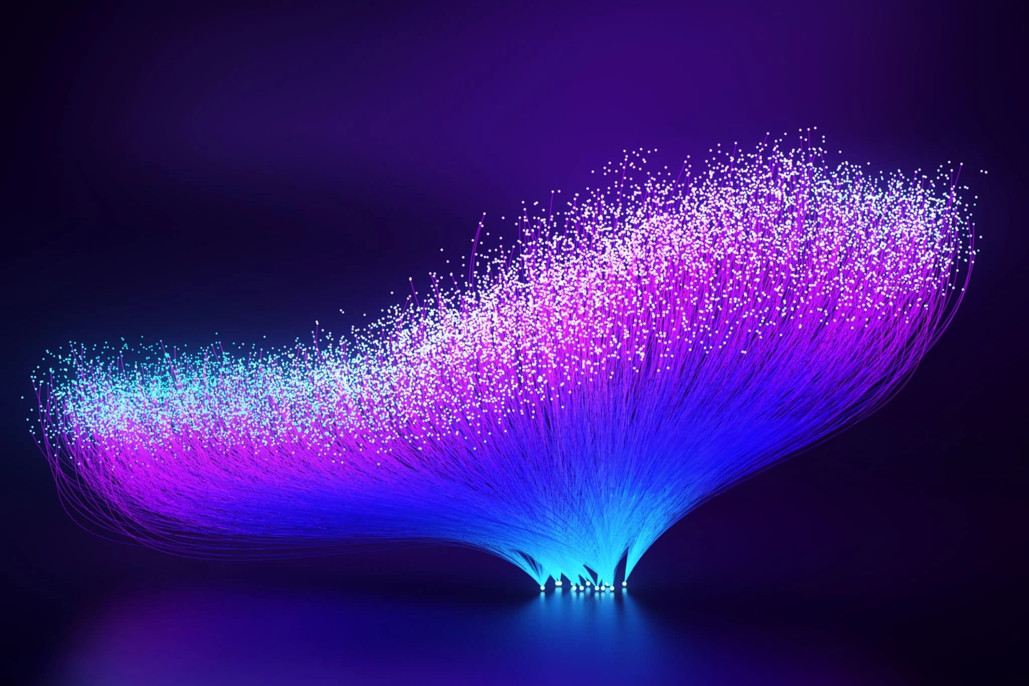 Luminous violet and blue particle form against a dark background.